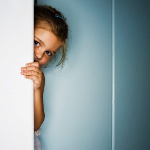 Girl Hiding Behind Door