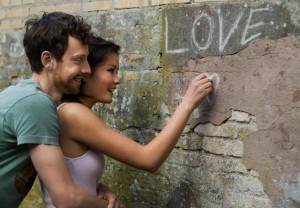 Girlfriend writing LOVE on a wall