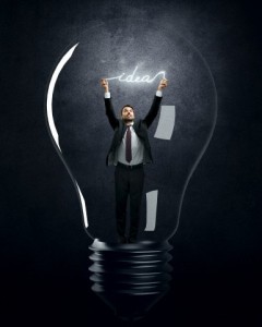 Businessman holding luminous message inside lamp