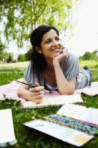 Mid-adult woman painting in park